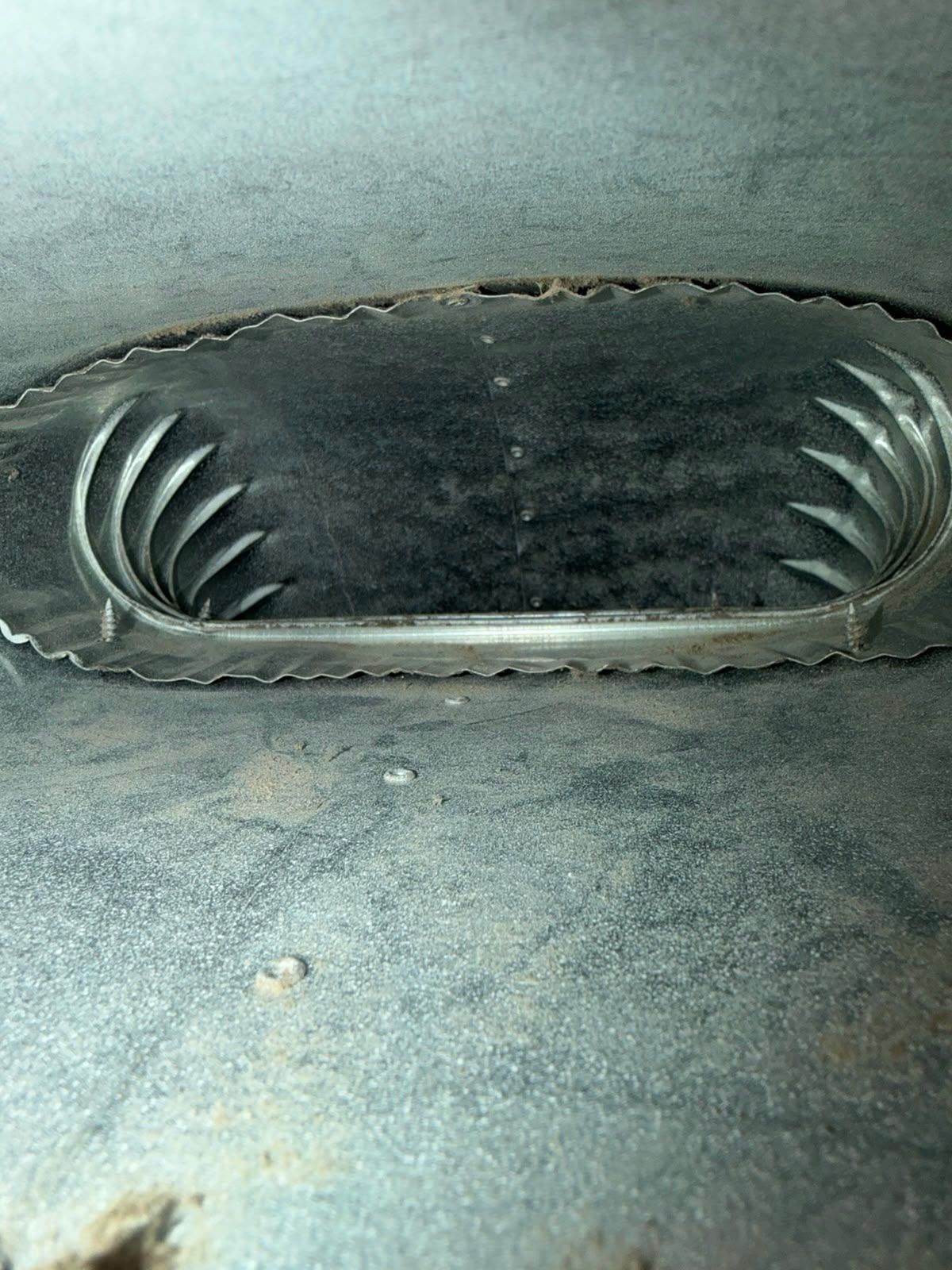 The same air duct interior showing bare metal after AMG cleaned it